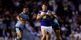 SYDNEY, AUSTRALIA - MARCH 29: Jack Todd of the Bulldogs is tackled by the Sharks defence during the round four NRL match between Cronulla Sharks and Canterbury Bulldogs at Sharks Stadium, on March 29, 2025, in Sydney, Australia. (Photo by Brendon Thorne/Getty Images)