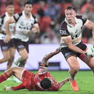 BRISBANE, AUSTRALIA - MARCH 28: Billy Walters of the Broncos is tackled during the round four NRL match between Dolphins and Brisbane Broncos at Suncorp Stadium, on March 28, 2025, in Brisbane, Australia. (Photo by Bradley Kanaris/Getty Images)