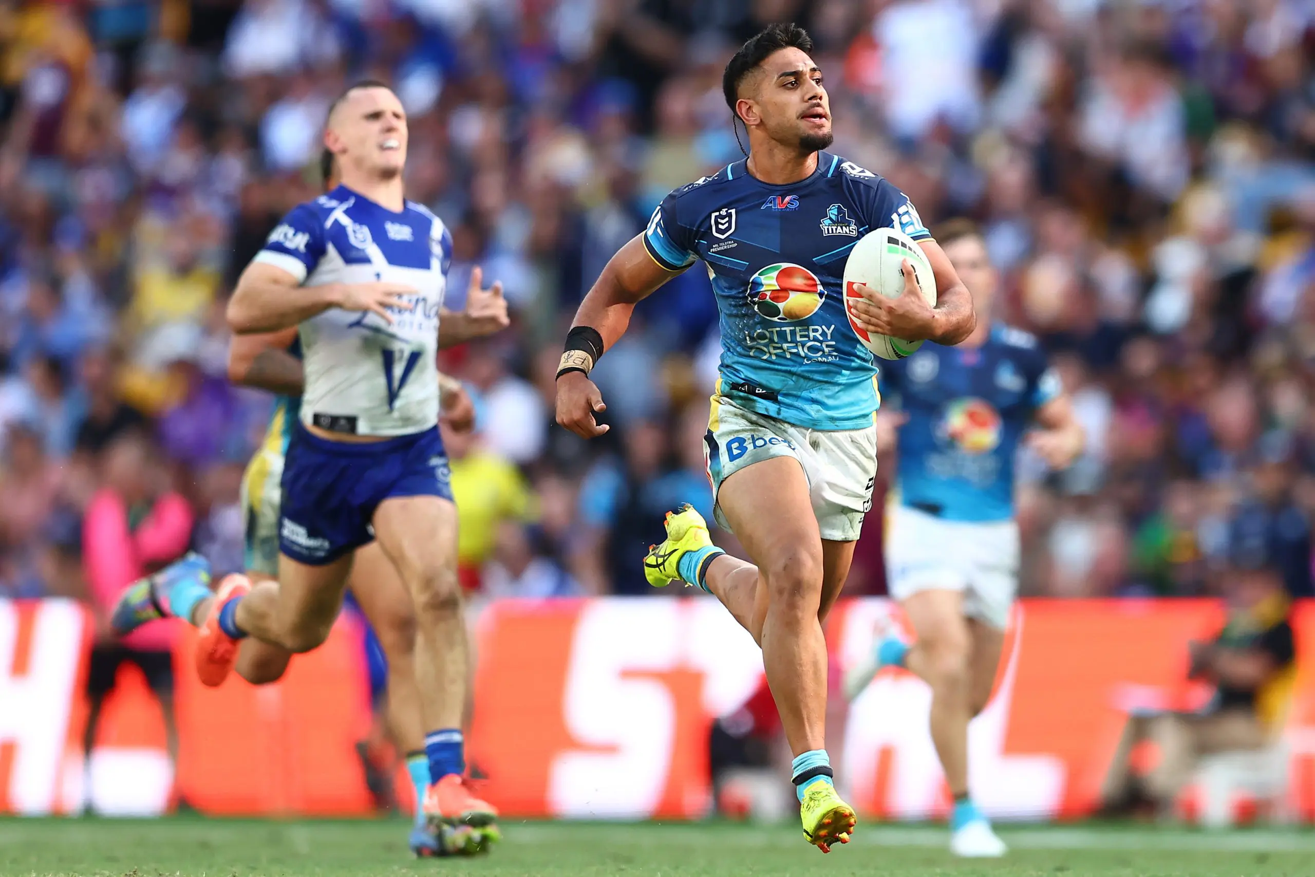 BRISBANE, AUSTRALIA - MAY 04: Alofiana Khan-Pereira of the Titans makes a break to score a try during the round nine NRL match between the Gold Coast Titans and Canterbury Bulldogs at Suncorp Stadium on May 04, 2025, in Brisbane, Australia. (Photo by Chris Hyde/Getty Images)