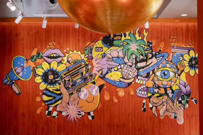 The restaurant features the brand's now-iconic disco balls and a custom mural from local artist Brent Smith.