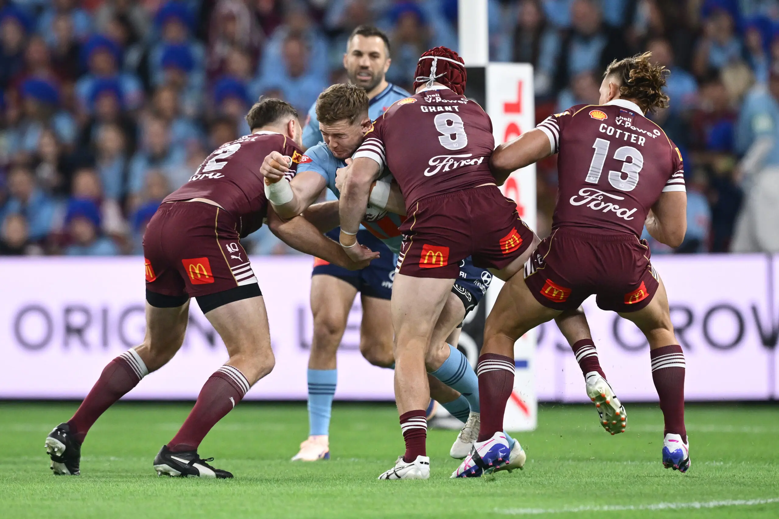 BRISBANE, AUSTRALIA - JULY 08: Hudson Young of the Blues is tackled during game three of the Men's State of Origin series between the Queensland Maroons and the New South Wales Blues at Suncorp Stadium on July 08, 2026 in Brisbane, Australia. (Photo by Bradley Kanaris/Getty Images)