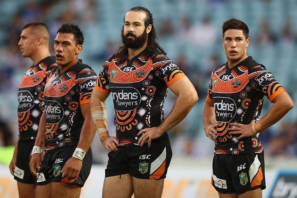 SYDNEY, AUSTRALIA - MAY 15: Elijah Taylor, Aaron Woods and Mitchell Moses of the Tigers look dejected after a Bulldogs try during the round 10 NRL match between the Wests Tigers and the Canterbury Bulldogs at ANZ Stadium on May 15, 2016 in Sydney, Australia. (Photo by Mark Kolbe/Getty Images)