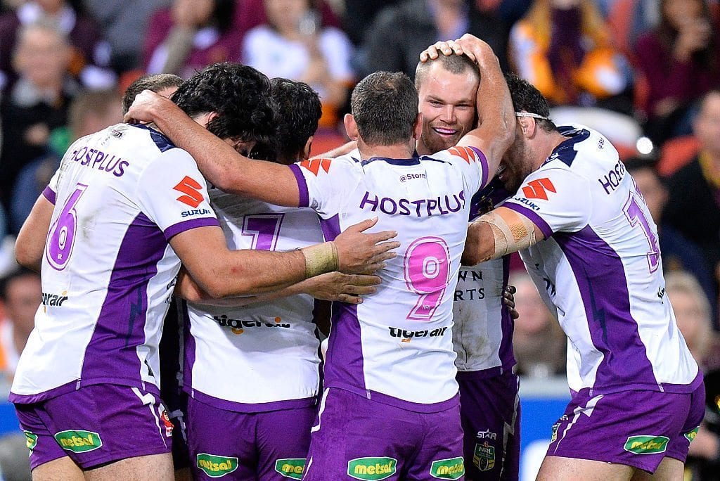 BRISBANE, AUSTRALIA - JULY 01:  Cheyse Blair of the Storm is congratulated by team mates after scoring a try during the round 17 NRL match between the Brisbane Broncos and the Melbourne Storm at Suncorp Stadium on July 1, 2016 in Brisbane, Australia.  (Photo by Bradley Kanaris/Getty Images)