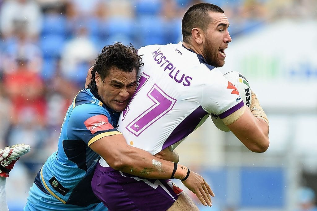 Nelson Asofa-Solomona of the Storm is tackled by Leivaha Pulu of the Titans during the round nine NRL match between the Gold Coast Titans and the Melbourne Storm on May 1, 2016 in Gold Coast, Australia.