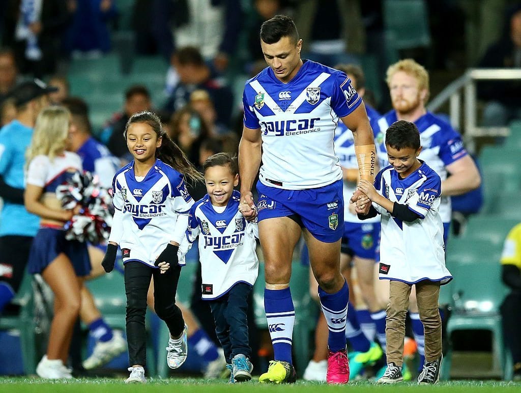 SYDNEY, AUSTRALIA - JUNE 30:  Sam Perrett of the Bulldogs walks onto the field with his children to celebrate his 250th game during the round 17 NRL match between the Sydney Roosters and the Canterbury Bulldogs at Allianz Stadium on June 30, 2016 in Sydney, Australia.  (Photo by Mark Nolan/Getty Images)