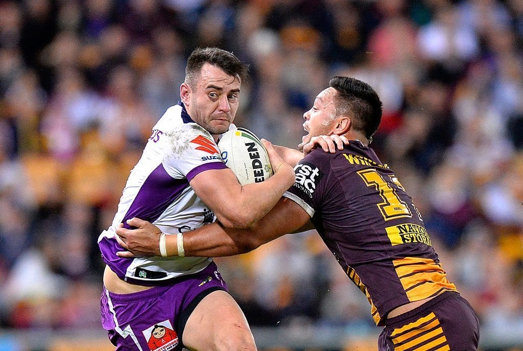 BRISBANE, AUSTRALIA - JULY 01: Ryan Morgan of the Storm attempts to break away from the defence during the round 17 NRL match between the Brisbane Broncos and the Melbourne Storm at Suncorp Stadium on July 1, 2016 in Brisbane, Australia. (Photo by Bradley Kanaris/Getty Images)