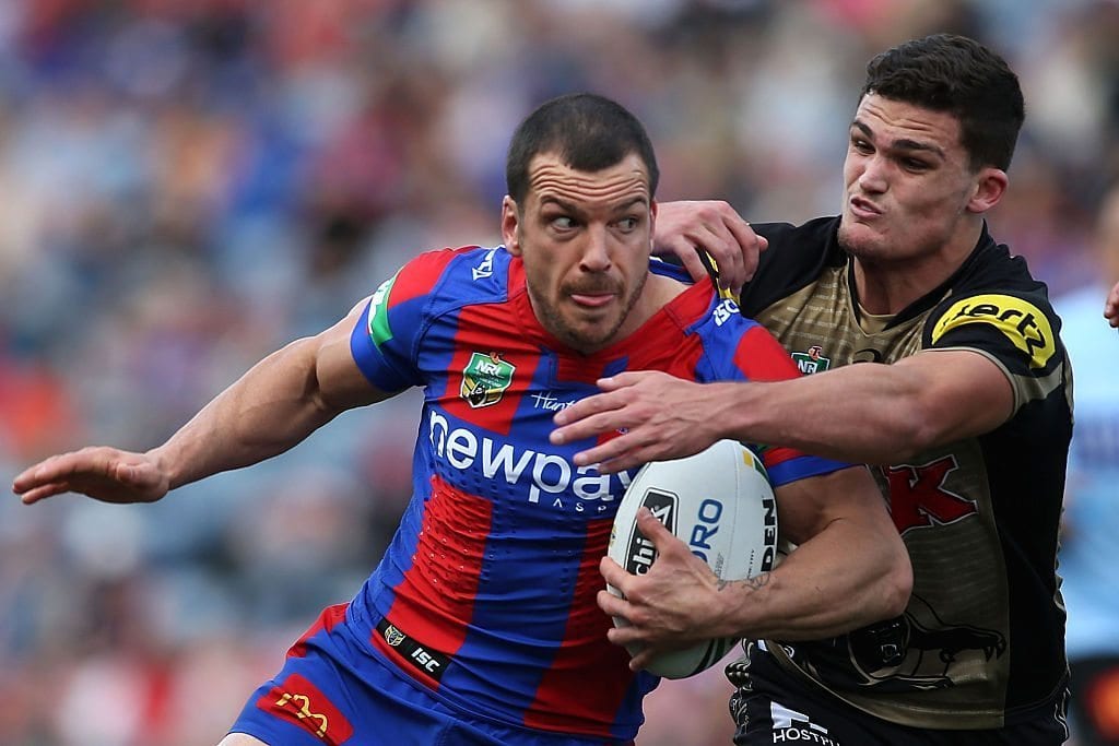 NEWCASTLE, AUSTRALIA - AUGUST 14: Jarrod Mullen of the Knights is tackled by Nathan Cleary of the Panthers during the round 23 NRL match between the Newcastle Knights and the Penrith Panthers at Hunter Stadium on August 14, 2016 in Newcastle, Australia. (Photo by Tony Feder/Getty Images)