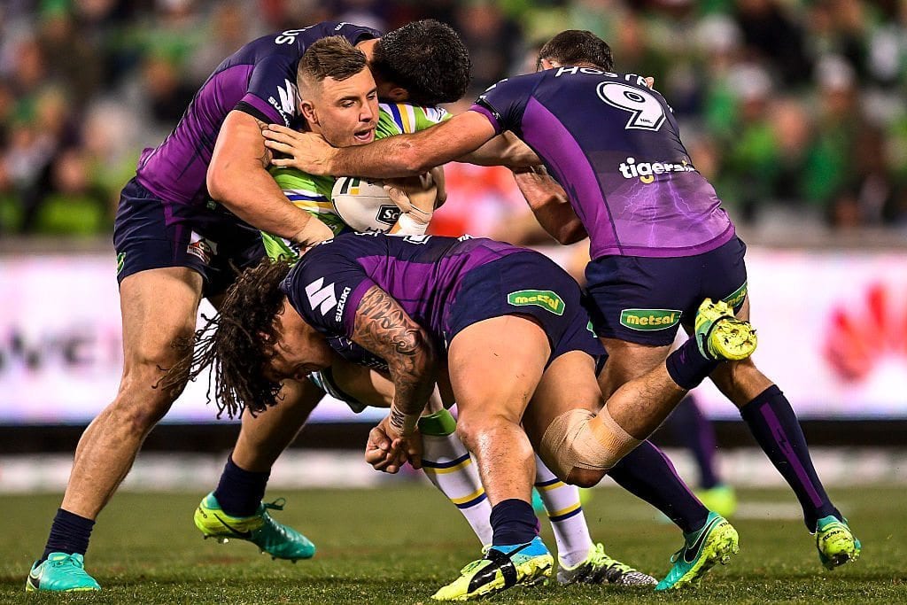 CANBERRA, AUSTRALIA - AUGUST 15: Clay Priest of the Raiders is tackled during the round 23 NRL match between the Canberra Raiders and the Melbourne Storm at GIO Stadium on August 15, 2016 in Canberra, Australia.  (Photo by Brett Hemmings/Getty Images)