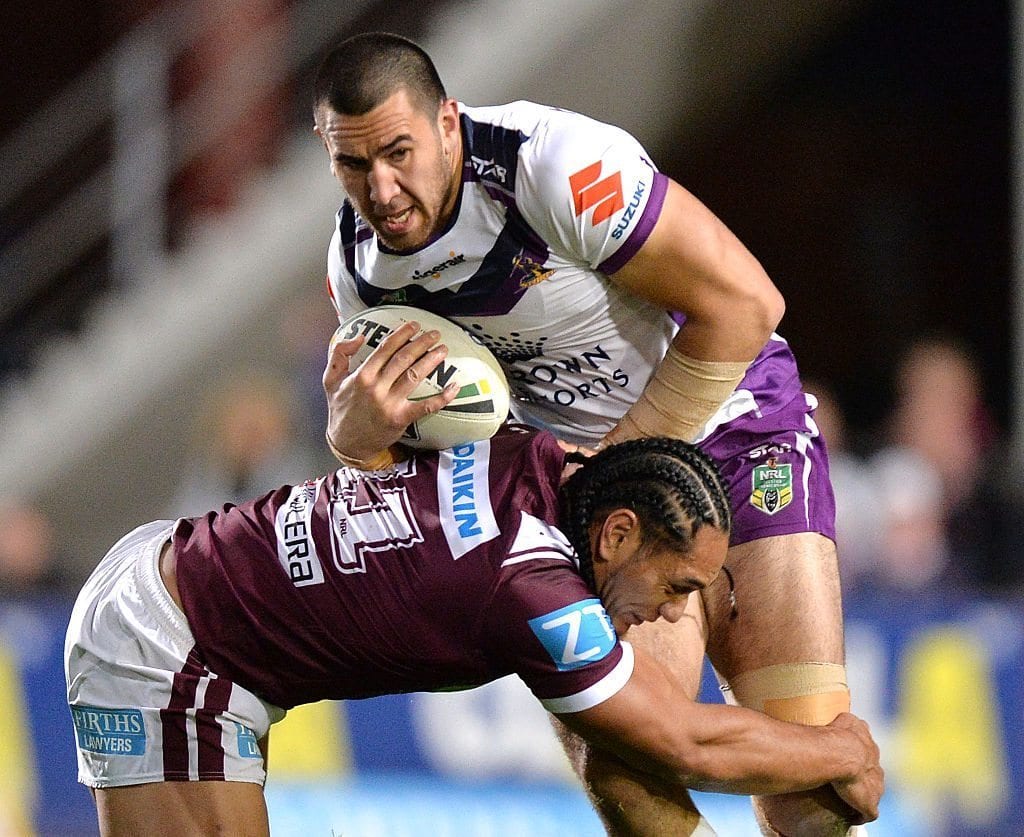 SYDNEY, AUSTRALIA - AUGUST 20:  Nelson Asofa-Solomona of the Storm is tackled during the round 24 NRL match between the Manly Sea Eagles and the Melbourne Storm at Brookvale Oval on August 20, 2016 in Sydney, Australia.  (Photo by Bradley Kanaris/Getty Images)