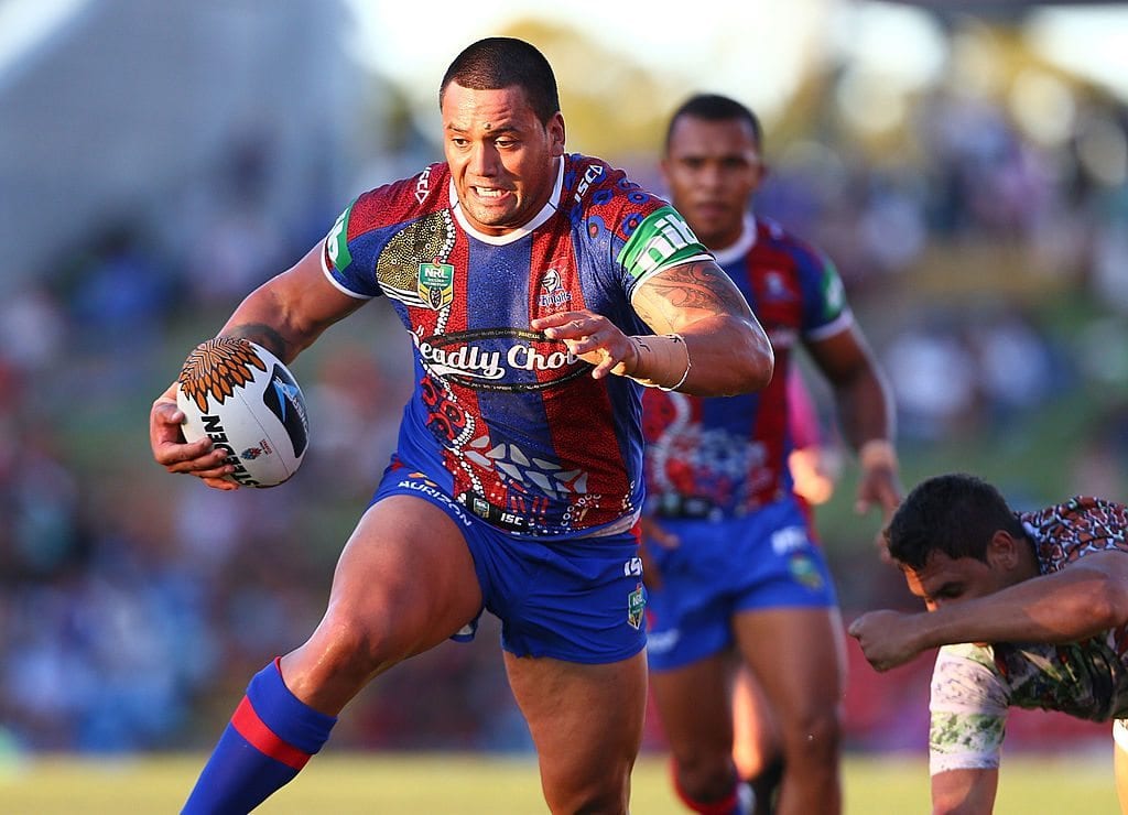 NEWCASTLE, AUSTRALIA - FEBRUARY 08: Zane Tetevano of the Knights gets away from Matthew Pitman during the NRL trial match between the Newcastle Knights and the First Nations Goannas at Hunter Stadium on February 8, 2014 in Newcastle, Australia. (Photo by Renee McKay/Getty Images)