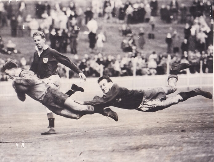 Balmain winger Bobby Lulham dives over the line to score against Newtown at the Sydney Cricket Ground.