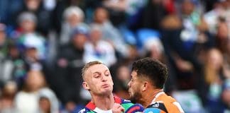 AUCKLAND, NEW ZEALAND - JULY 13: Tanah Boyd of the Warriors is tackled by Starford To'a of the Wests Tigers during the round 19 NRL match between New Zealand Warriors and Wests Tigers at Go Media Stadium, on July 13, 2025, in Auckland, New Zealand. (Photo by Dave Rowland/Getty Images)